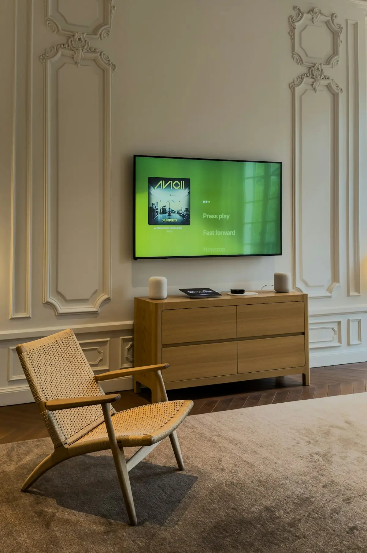 Person relaxing on a sofa while watching television in a dark living room